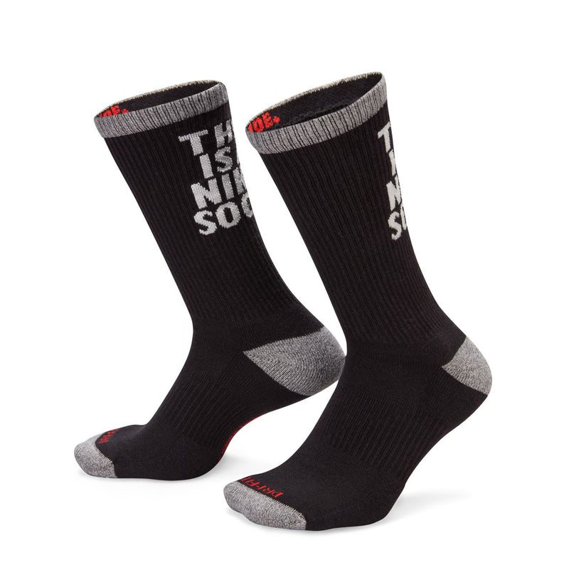 Black cushioned crew socks with gray toe/heel and 'THIS IS A NIKE SOCK' on the shaft