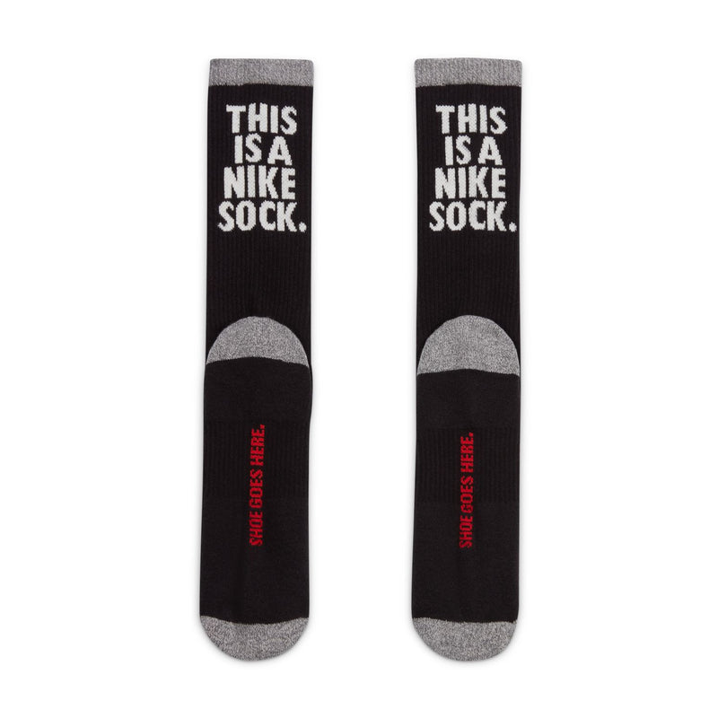 Black crew socks with gray toe/heel and white 'THIS IS A NIKE SOCK' text on legs