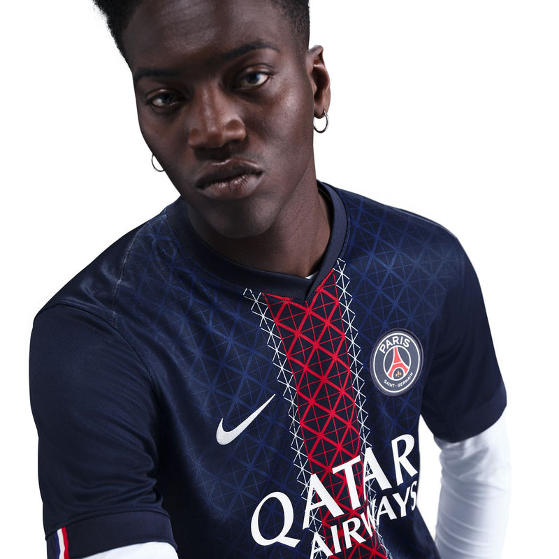 Men's PSG stadium home jersey close-up, crest, Nike swoosh, and QATAR AIRWAYS text