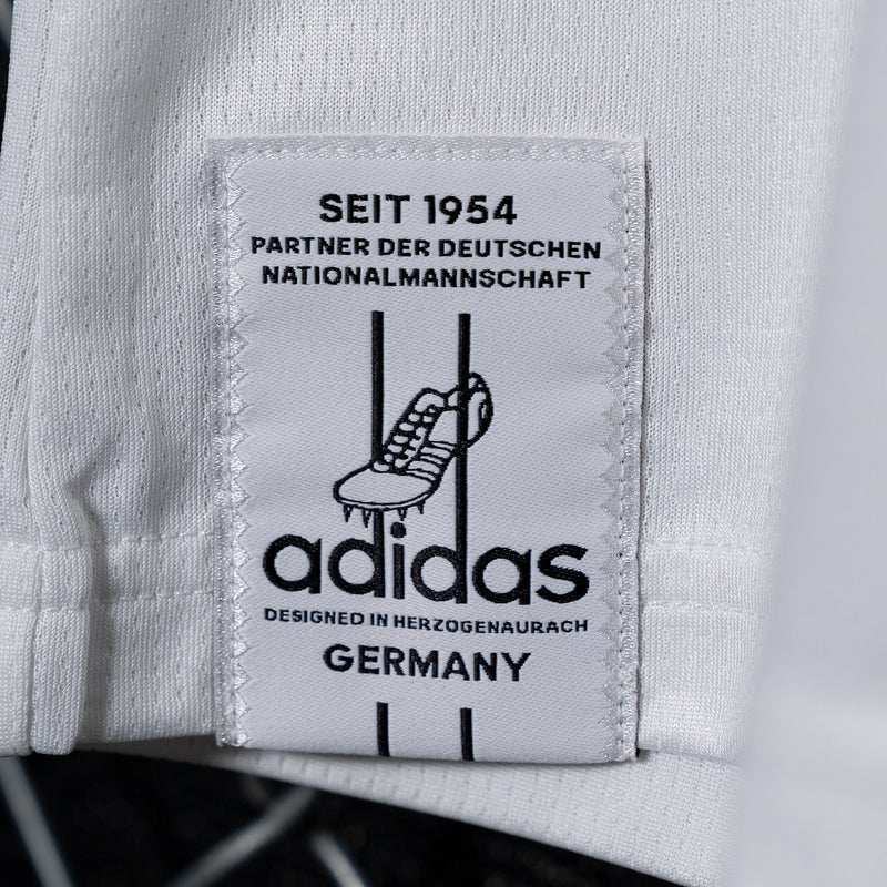 White inner label patch with adidas logo and text "DEUTSCHER NATIONALMANNSCHAFT"
