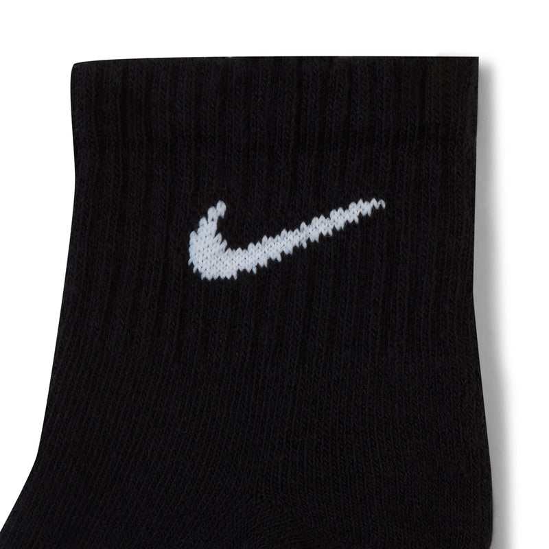 Black quarter crew sock with white Nike swoosh logo, cushioned knit texture
