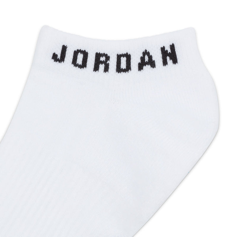 No-show sock close-up, white fabric with black JORDAN logo on cuff