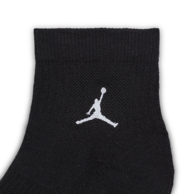 Black quarter crew sock with white Air Jordan logo on ankle