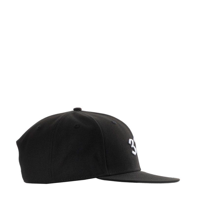 Black baseball cap side view with small white '3' logo and flat brim