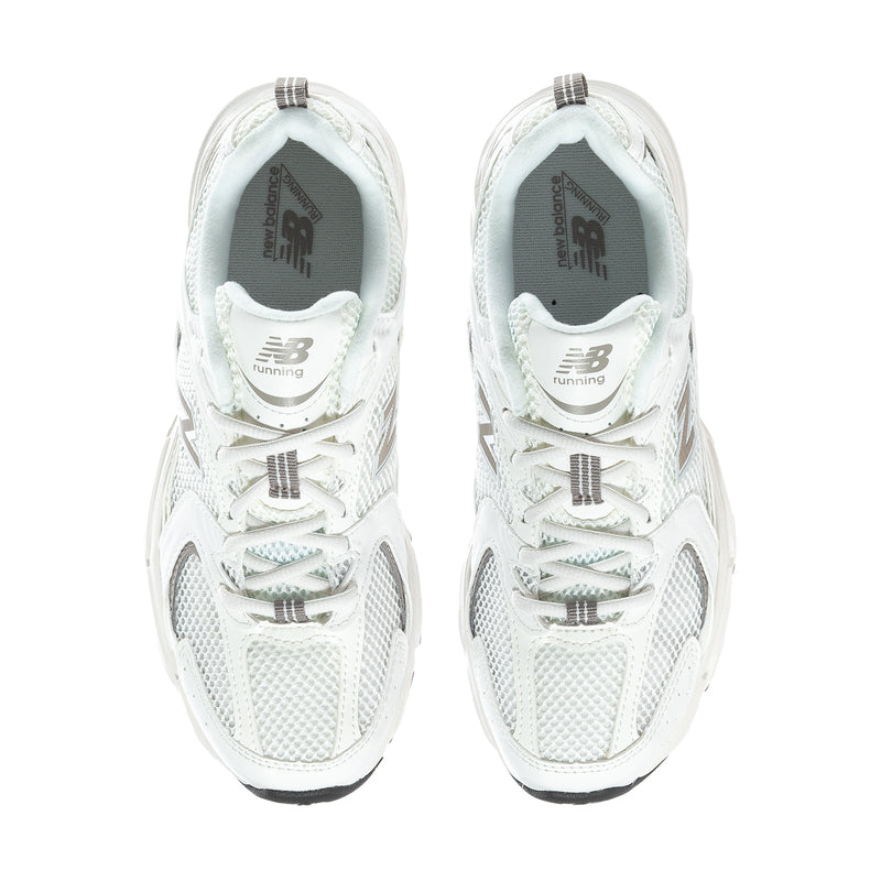 Pair of off-white New Balance 530 wide sneakers with lace-up front and padded collars