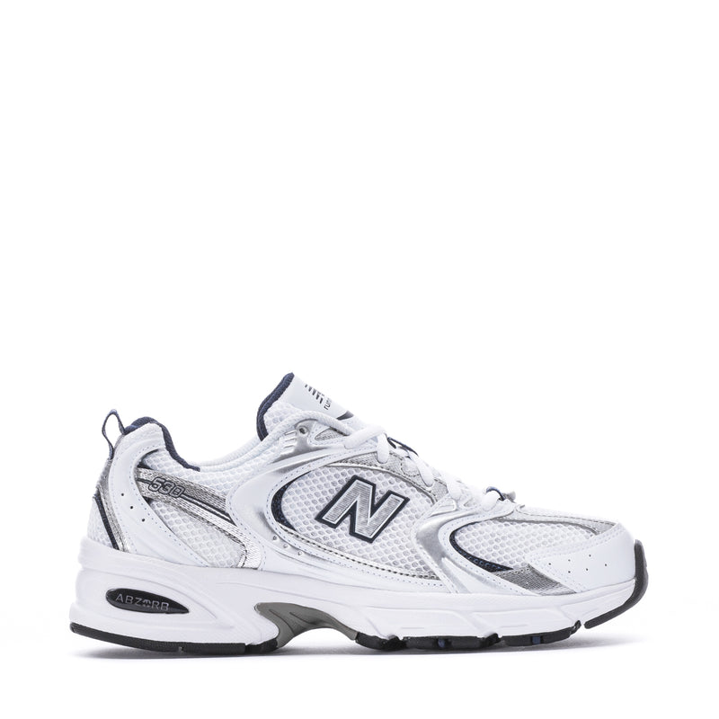 Women’s wide white and navy New Balance sneakers with oversized N logo, lace-up design.