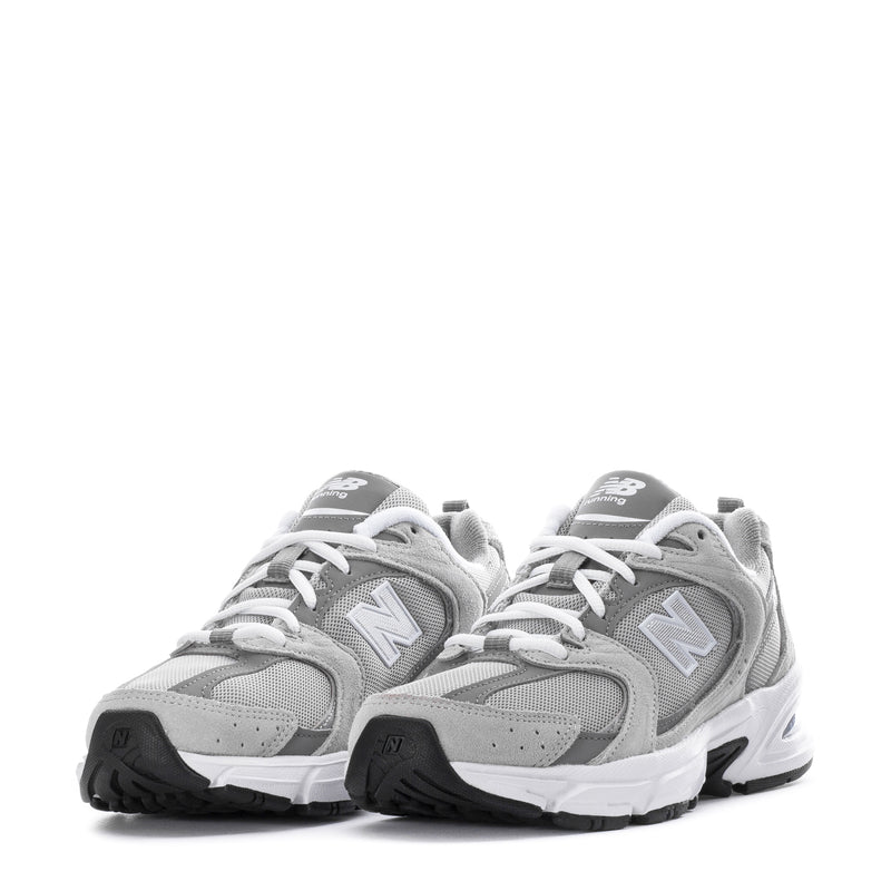 Pair of women's wide gray New Balance 530 sneakers with white laces and N logos
