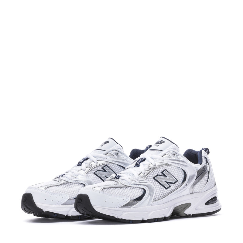Pair of women’s wide white and navy sneakers with speckled details, lace-up front view.