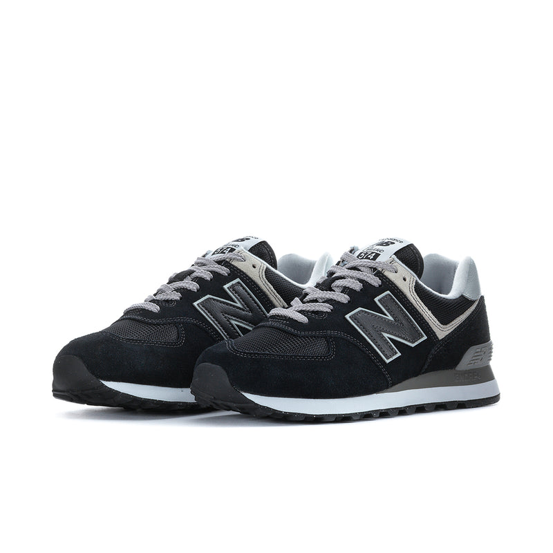 Men's New Balance 574 extra-wide sneakers, front pair view in black with white accents.