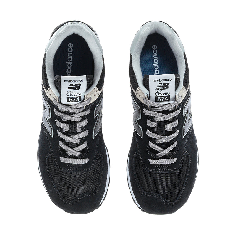 Men's New Balance 574 extra-wide sneakers, top view showing tongue label and laces.