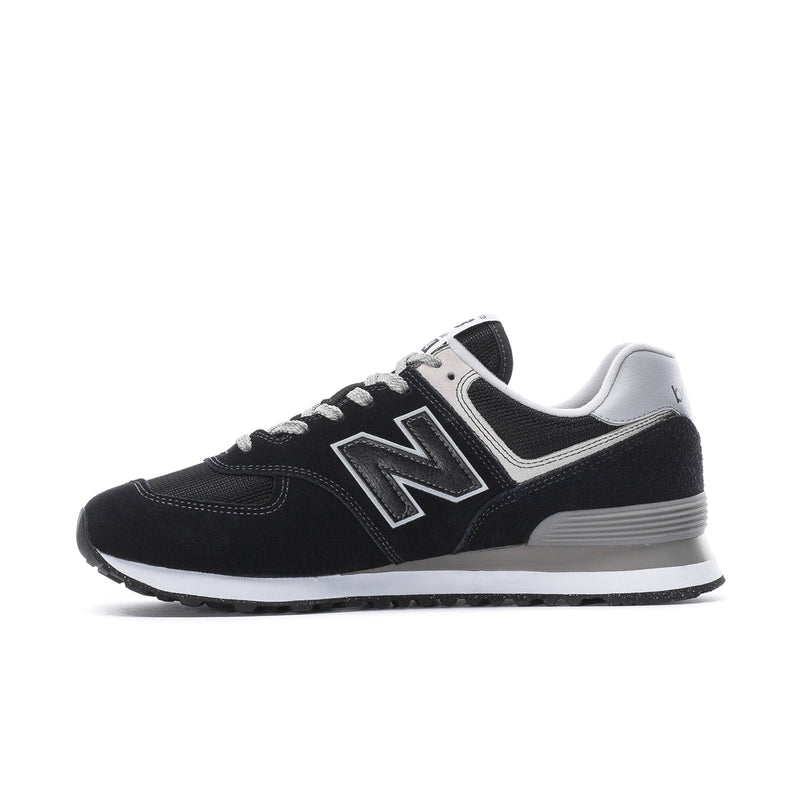 Men's New Balance 574 extra-wide sneakers, side view in black with white N logo.
