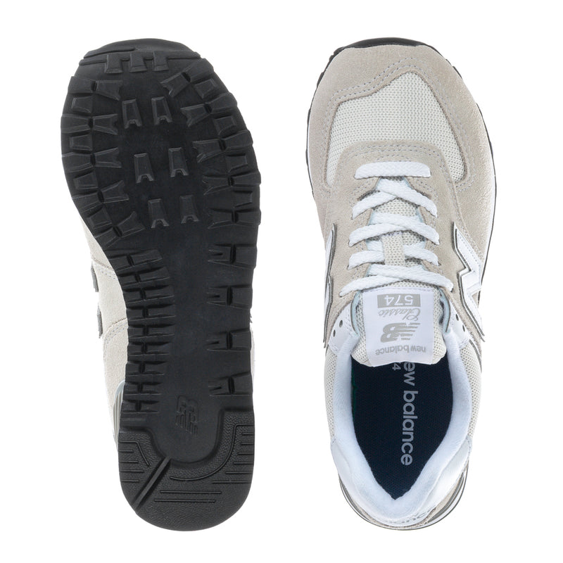 Women's New Balance 574 wide sneakers: white laces, blue lining, textured outsole.