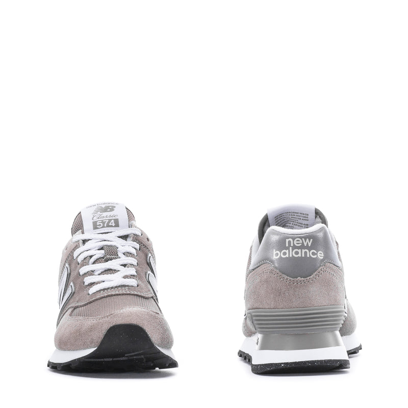 Pair of women's New Balance 574 sneakers, front and heel view in grey and white
