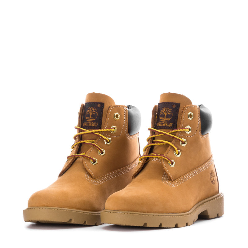 Kids tan lace-up boots with black ankle panels and Timberland logos