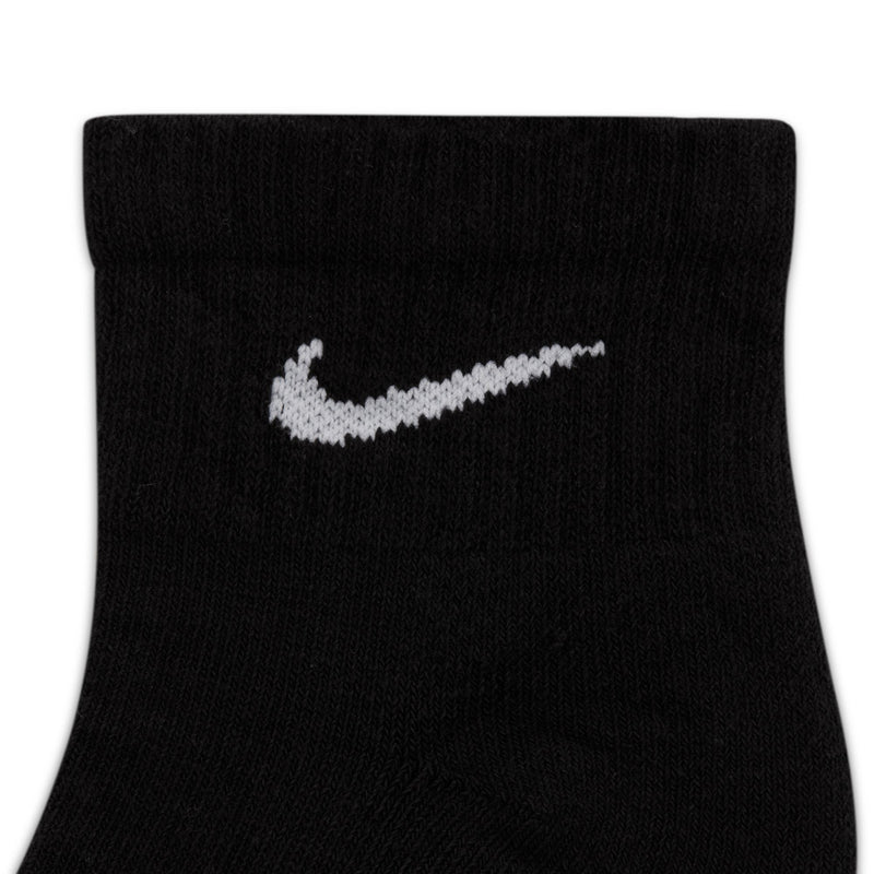 Black quarter sock close-up with white Nike swoosh logo on knit