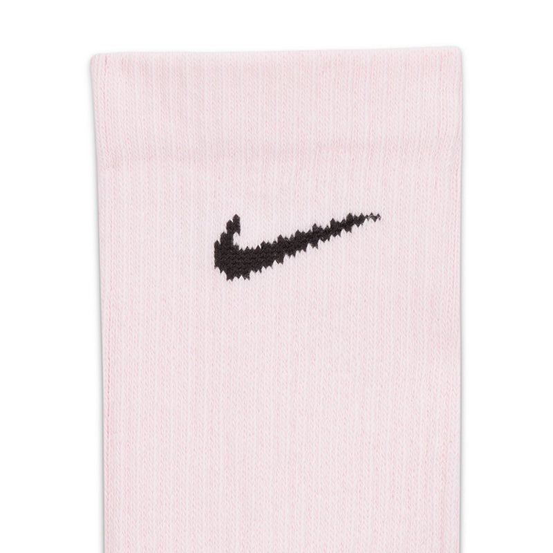 Light pink crew sock close-up with black Nike swoosh on the front.