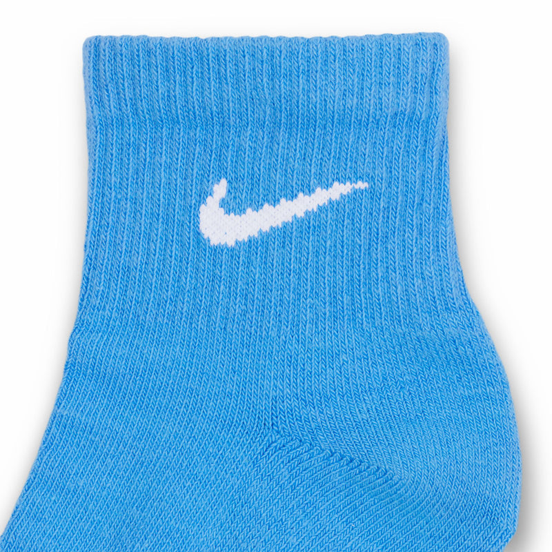 Light blue quarter sock cuff with white Nike swoosh logo and ribbed knit