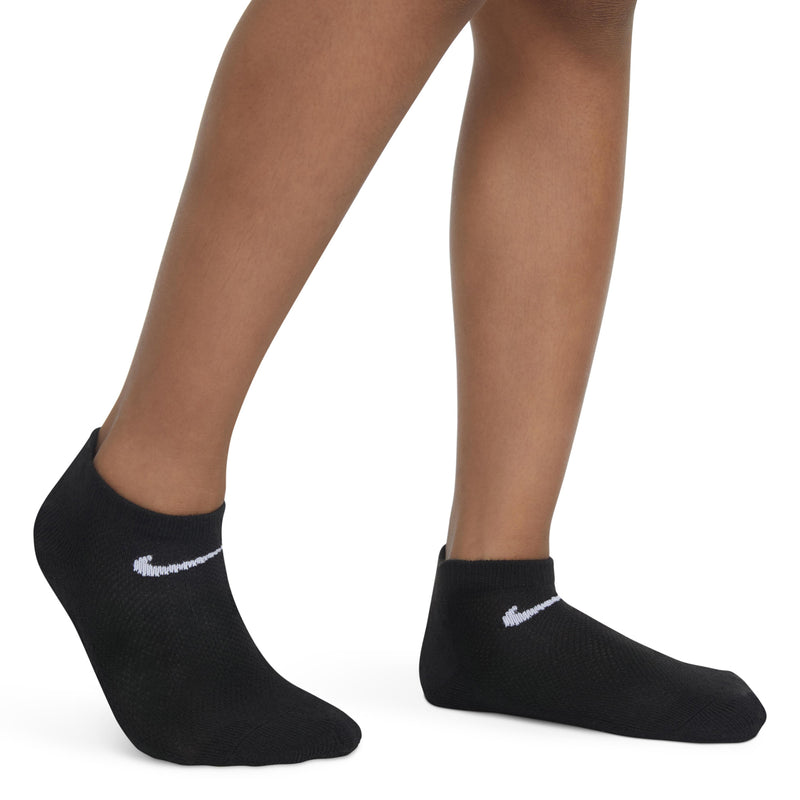 Black no-show socks with white swoosh logo, worn on feet with low-cut style