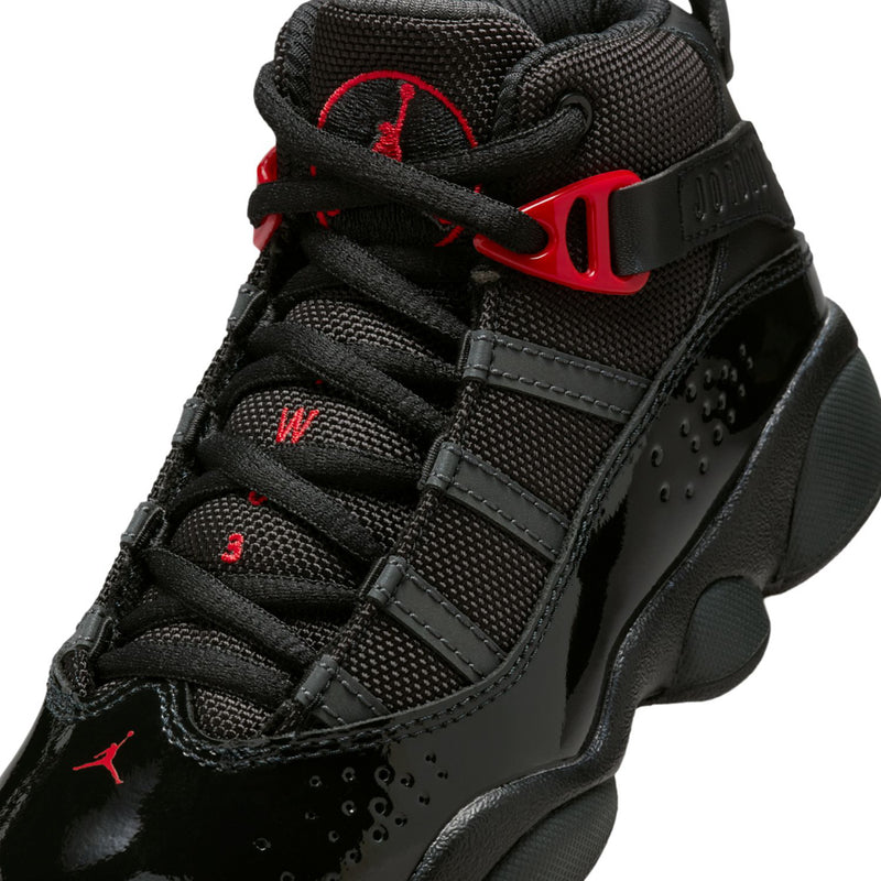 Kids black high-top sneakers close-up: red Jumpman details, mesh panels, lace-up