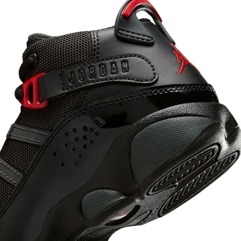 Kids black high-top sneakers close-up with red strap, textured upper, Jumpman logo