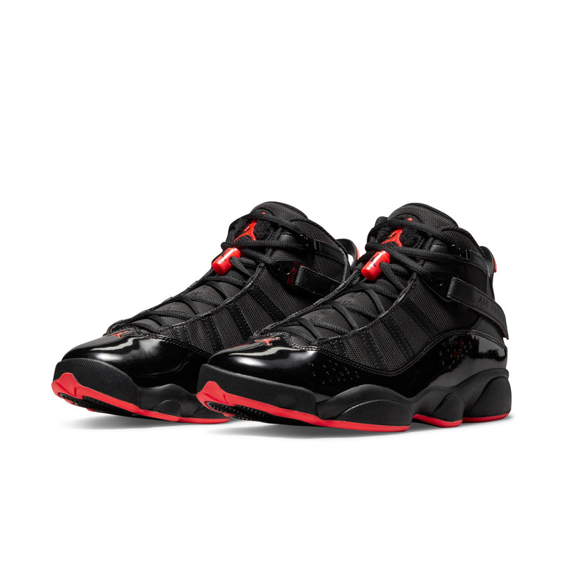 Pair of men's black high-top sneakers with red lace accents and stitched panels
