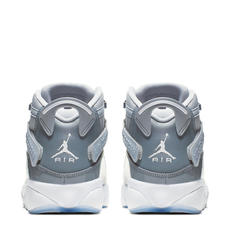 Heel view of grey and white mid-top sneakers with Air branding and pull tab