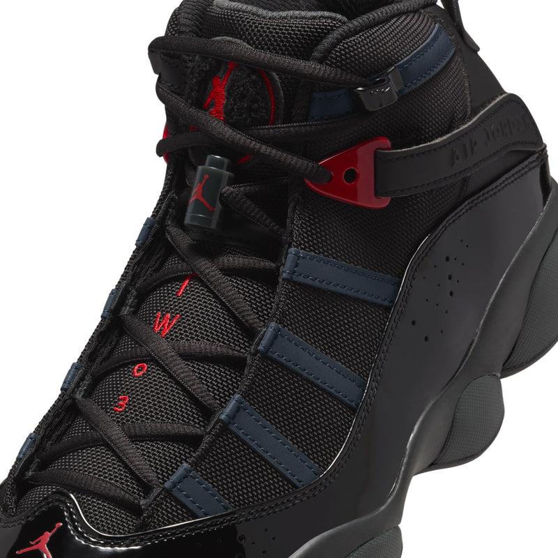 Close-up of men's high-top shoe tongue and laces in black with blue and red details