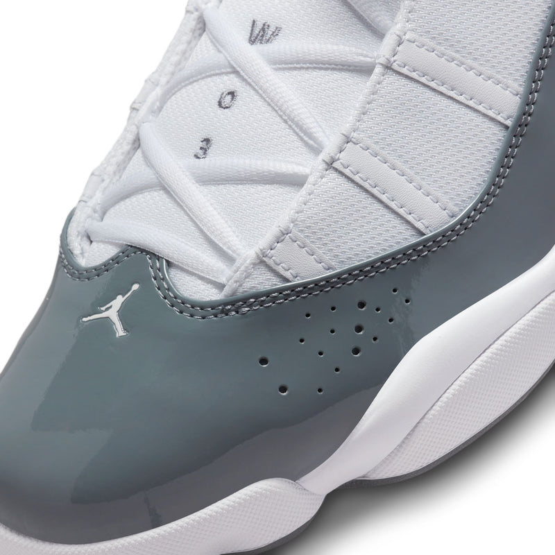 Men's high-top sneaker upper close-up, white laces, grey overlays, perforations