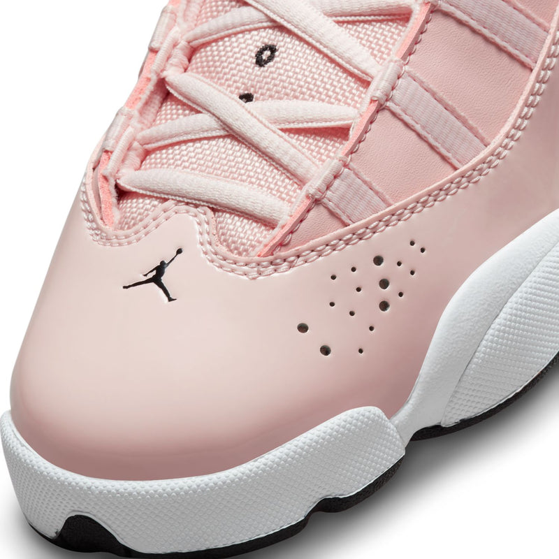 Close-up of pink sneaker toe with perforations, stitched seams, and black Jordan logo