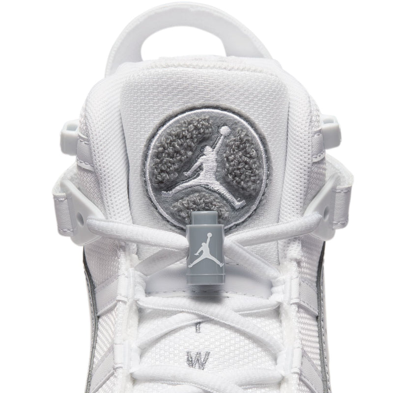 Youth sneaker tongue patch with Jumpman emblem on white fabric.