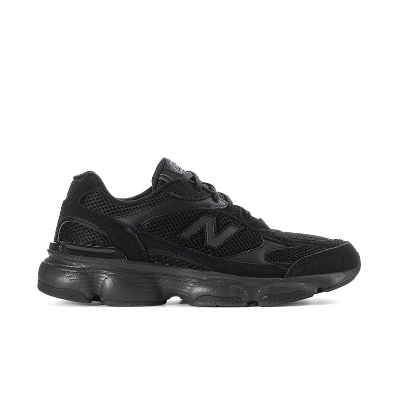 Black athletic sneaker with mesh upper, lace-up, and thick cushioned sole