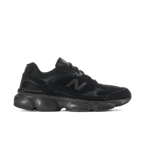 Black athletic sneaker with mesh upper, lace-up, and thick cushioned sole