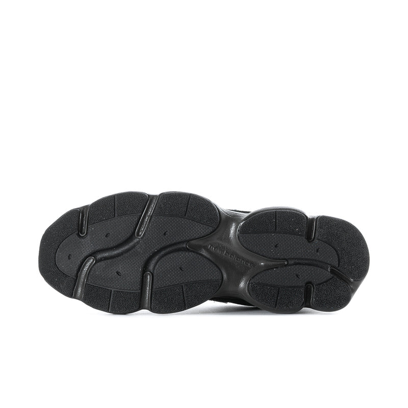 Black athletic sneaker outsole, textured tread bottom view
