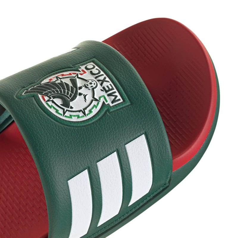 Close-up of green slide sandal strap with Mexico crest and white triple stripes