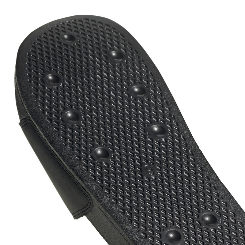 Black textured outsole tread with raised grip nubs for men's slide sandals
