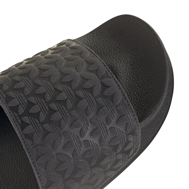 Men's black slide sandals close-up of leaf-patterned strap and textured upper
