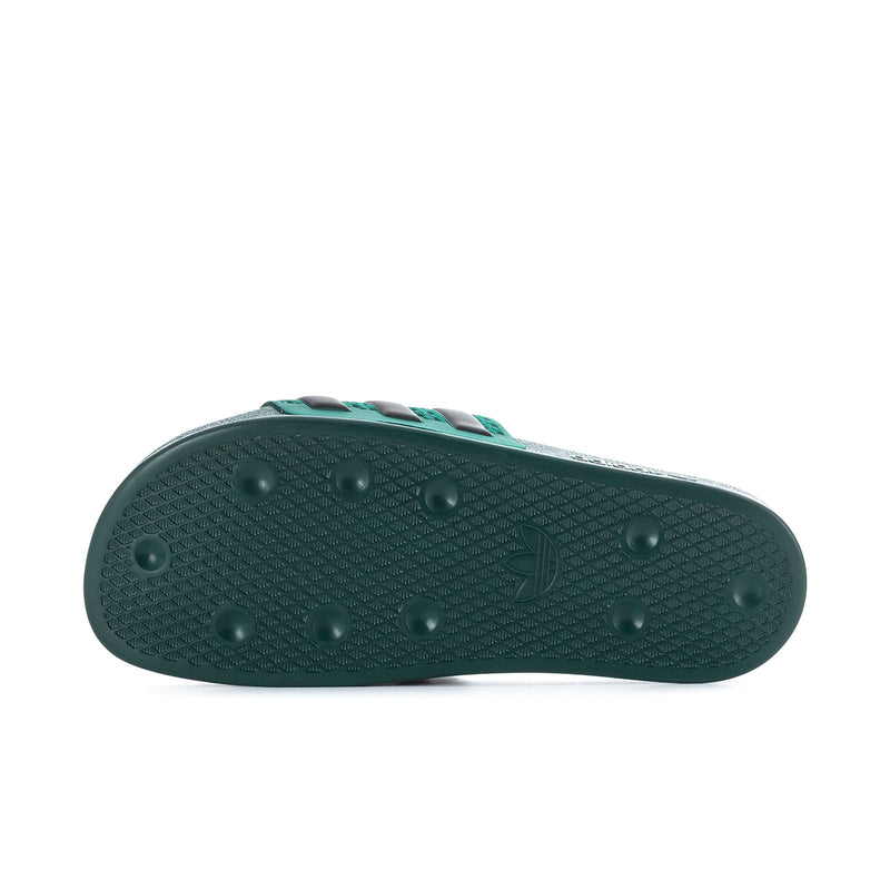 Men's green slide sandal outsole with textured tread and grip dots