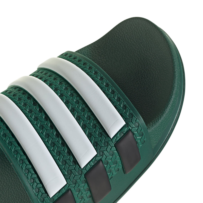Men's green slide sandal upper close-up with white stripe bands and woven texture