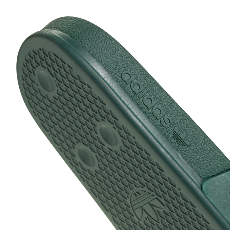 Men's green slide sandal footbed and outsole branding with textured pattern