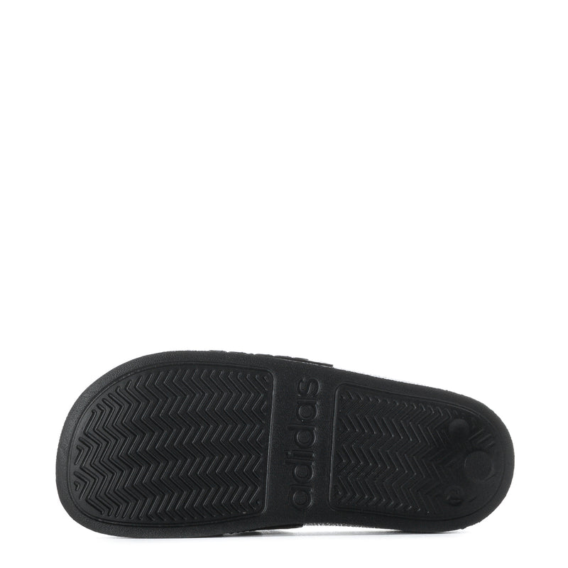 Kids black slide sandal outsole with zigzag tread and adidas logo