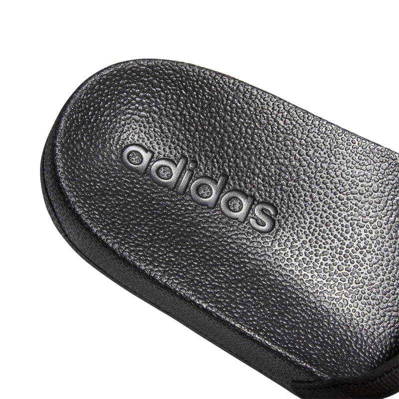 Kids black slide sandal footbed with adidas logo textured surface