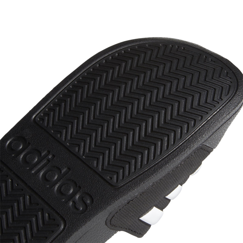 Kids black slide sandal outsole tread with adidas branding details
