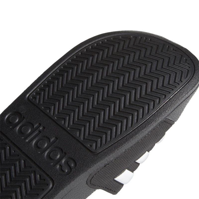 Black outsole tread close-up with adidas branding and textured grip detail