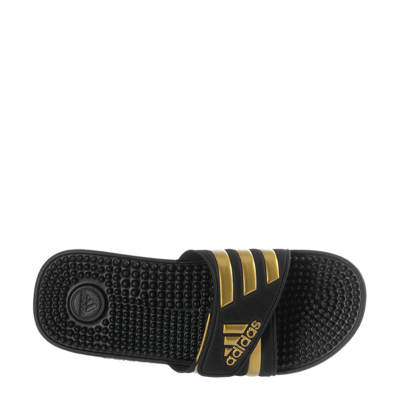 Men's black slide sandal outsole with textured tread and gold accent band