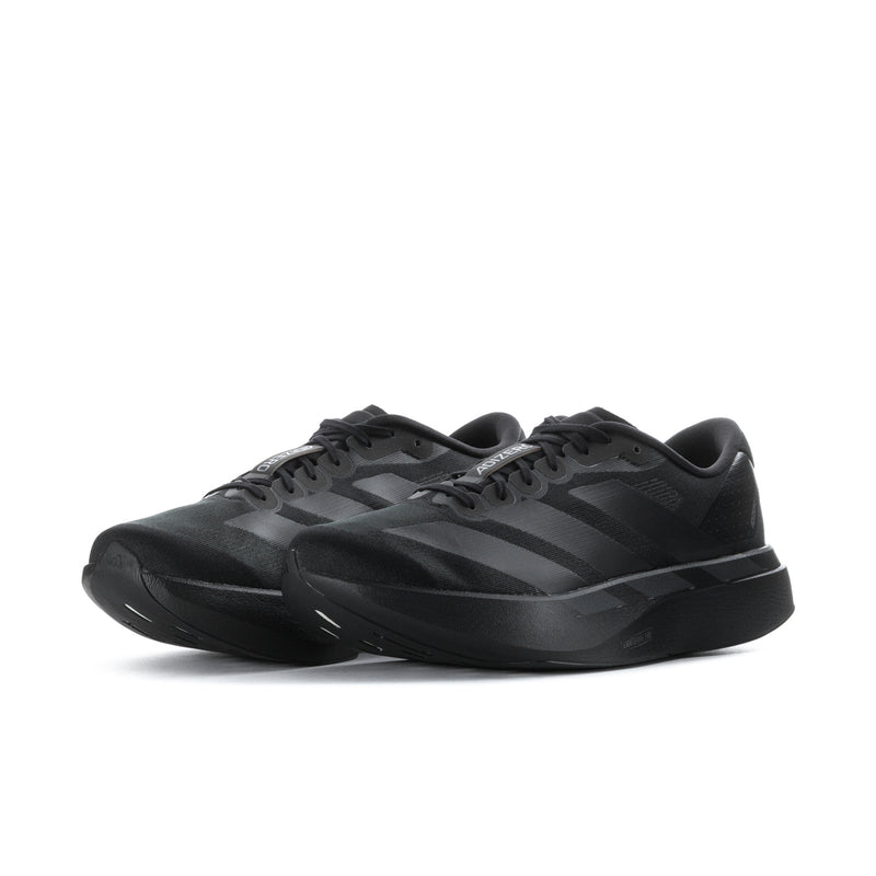 Black running sneakers with three-tone diagonal stripes and lace-up upper