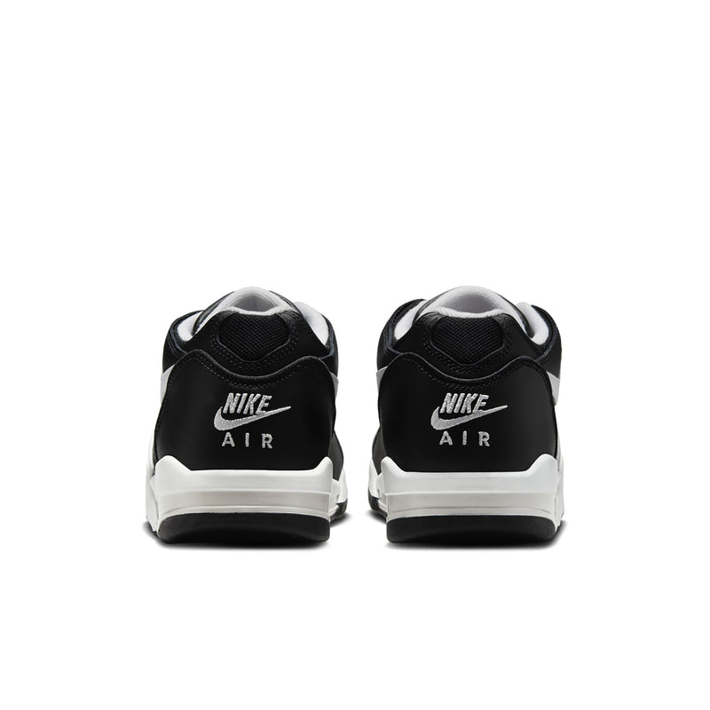 Black Air sneakers with white heel tabs, back view with durable outsole