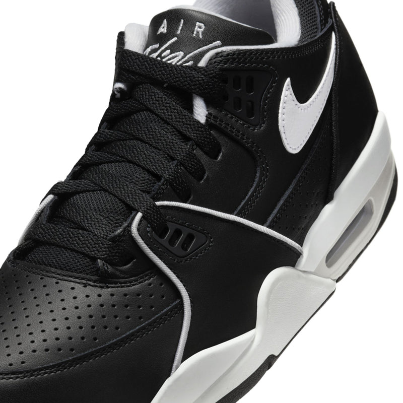 Black Air sneaker close-up with white swoosh, perforations, and lace details