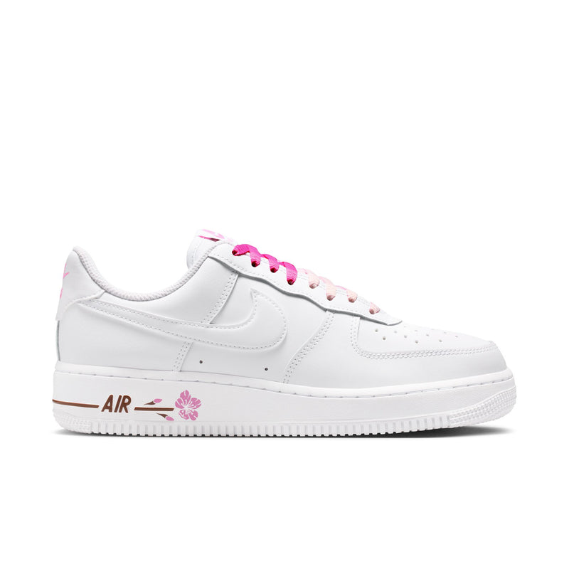 Women’s white low-top sneakers with pink laces and floral side logo