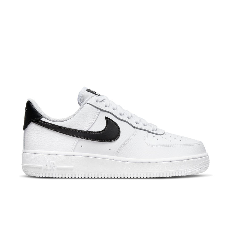 Women’s white low-top sneaker with black Swoosh and perforated toe box