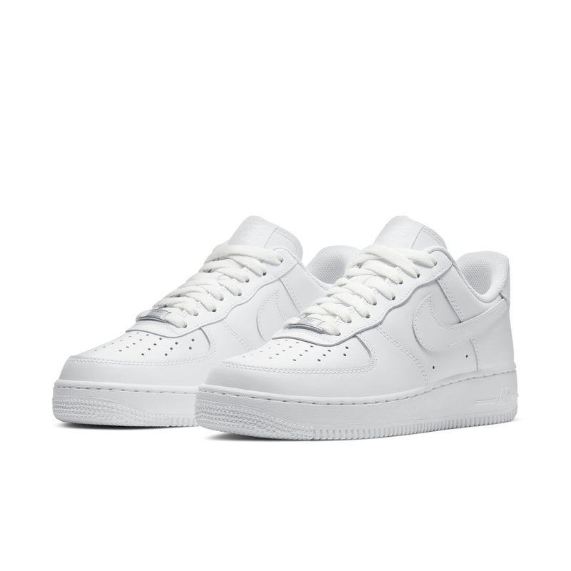 Women's white low-top sneakers, front view with Nike Swoosh, lace-up